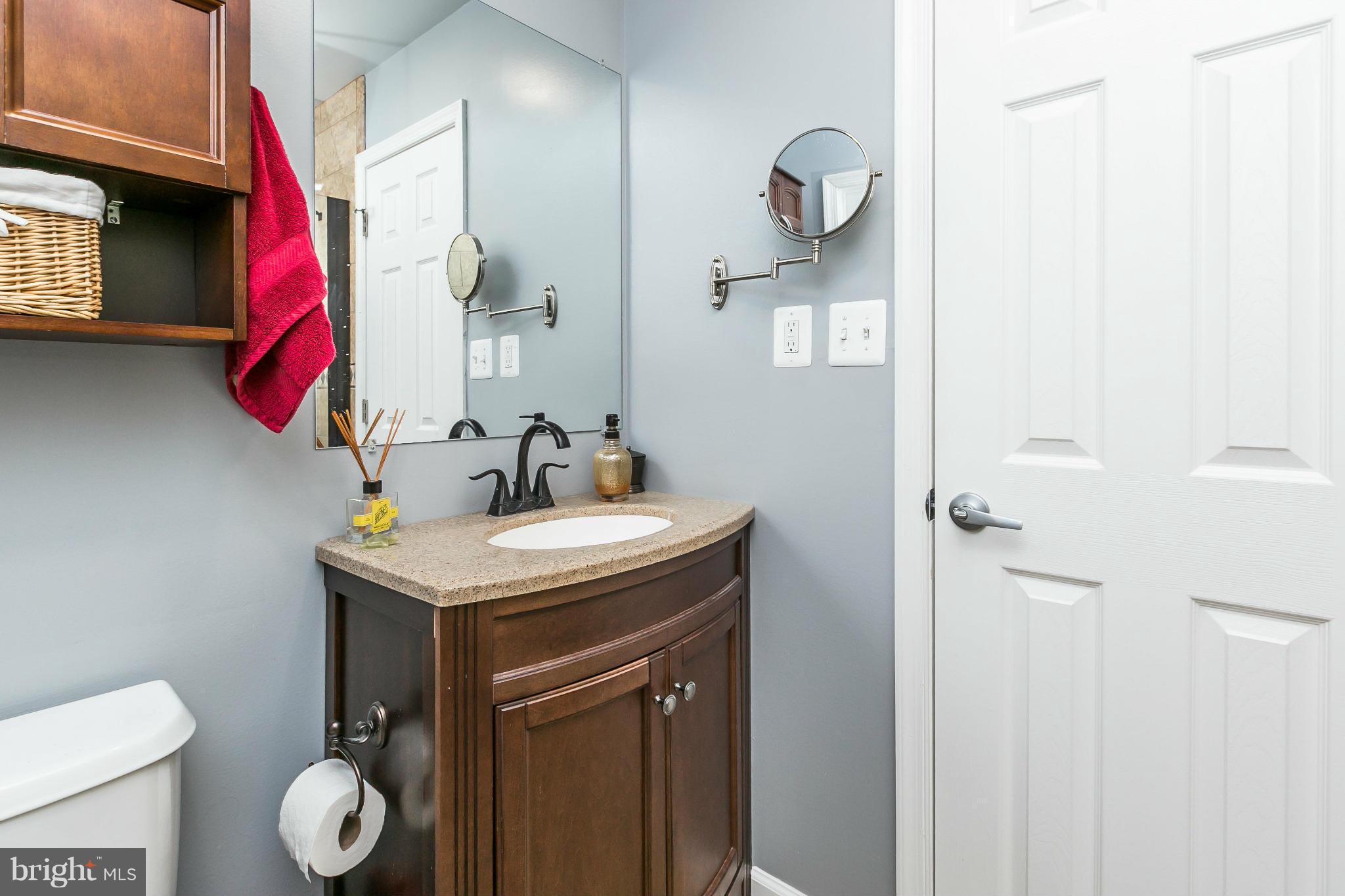 2 West Lee Street, Unit R59 Baltimore, MD 21201 - Photo 20 of 28 a bathroom with a toilet sink and mirror
