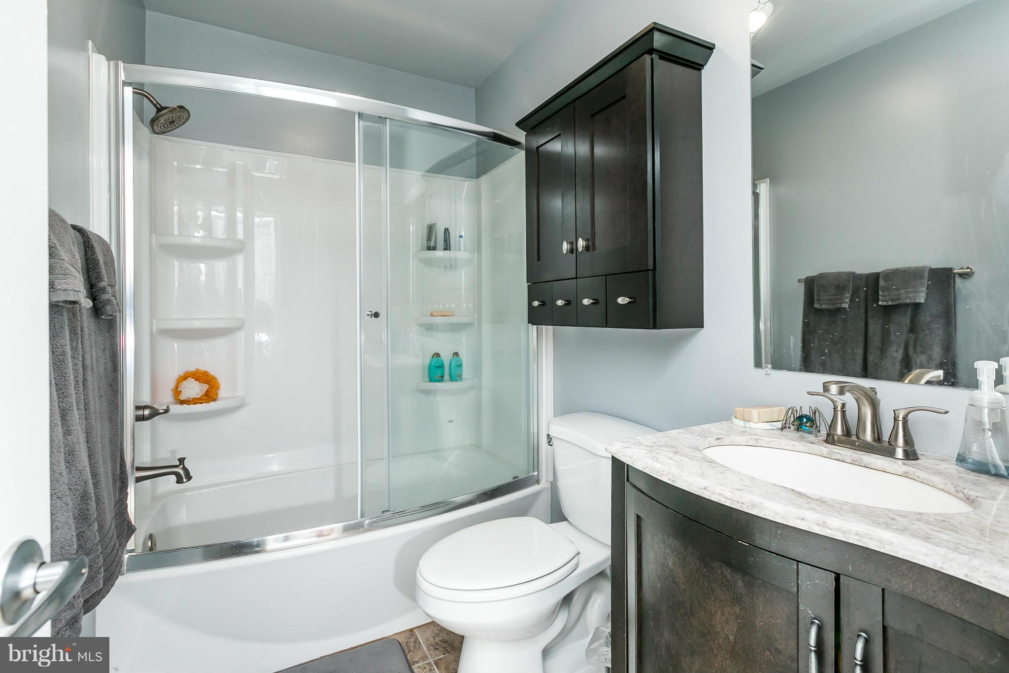 2 West Lee Street, Unit R59 Baltimore, MD 21201 - Photo 23 of 28 a bathroom with a granite countertop sink toilet and shower
