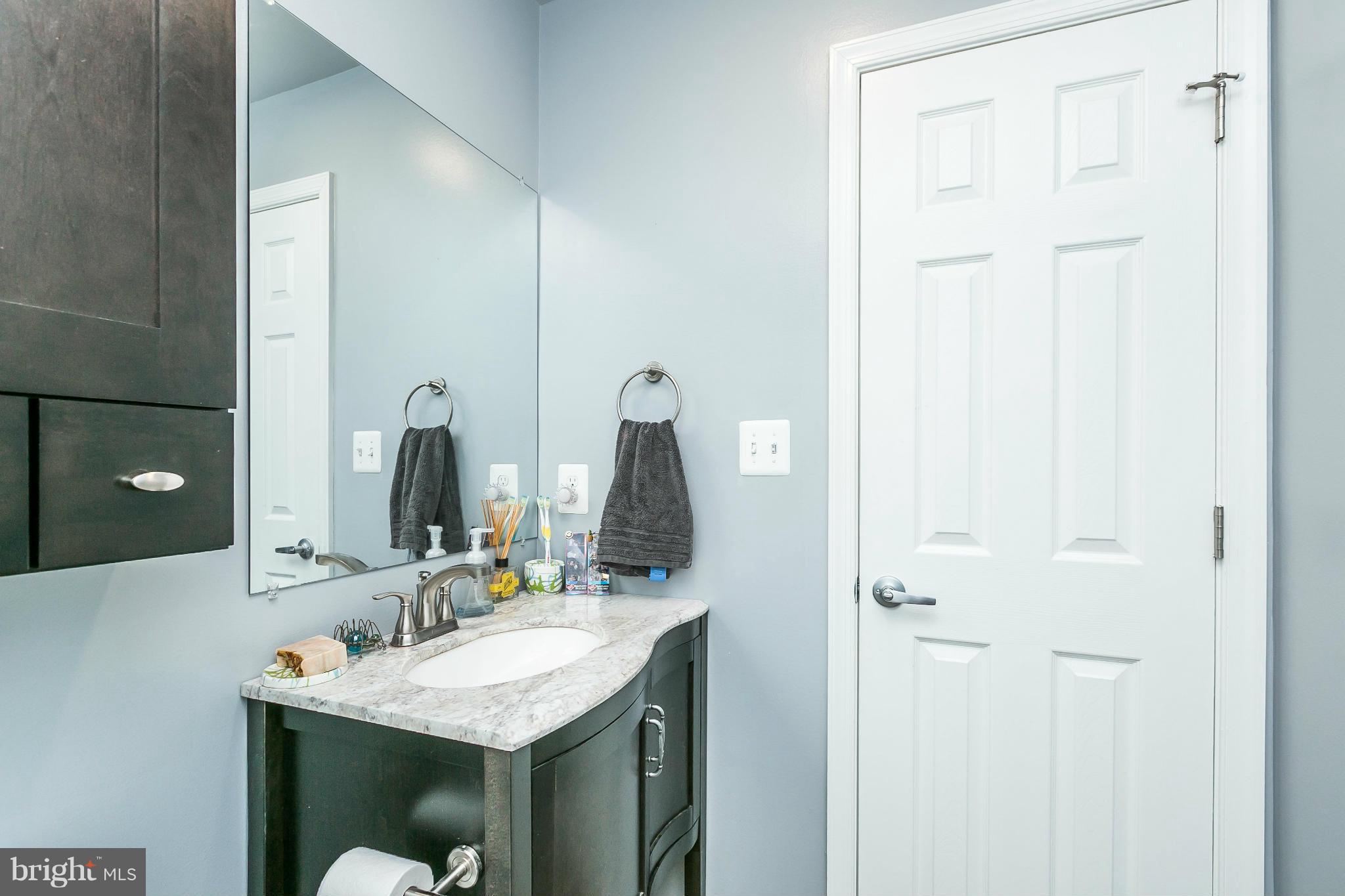 2 West Lee Street, Unit R59 Baltimore, MD 21201 - Photo 24 of 28 a bathroom with a sink and a mirror