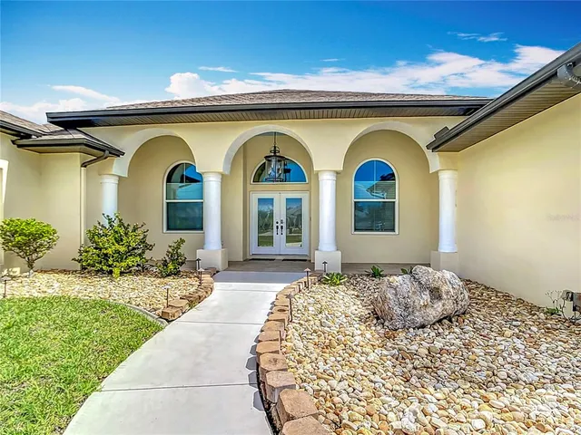 a bedroom with furniture and large windows