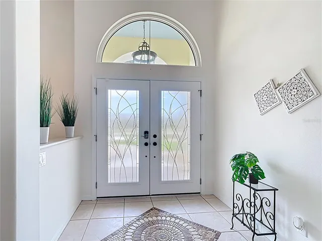 a dining room with furniture a rug and a chandelier