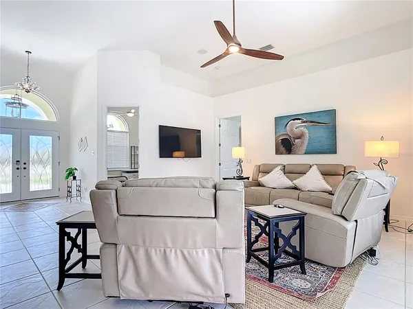 a kitchen with stainless steel appliances granite countertop white cabinets a sink and a large window