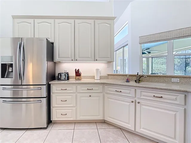 a bedroom with a large bed and wooden floor