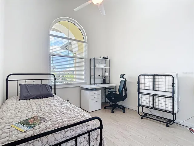 a bedroom with a bed and a tv on the dresser
