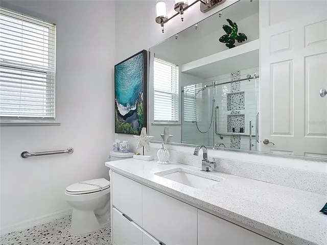 a bedroom with a large bed and a chandelier