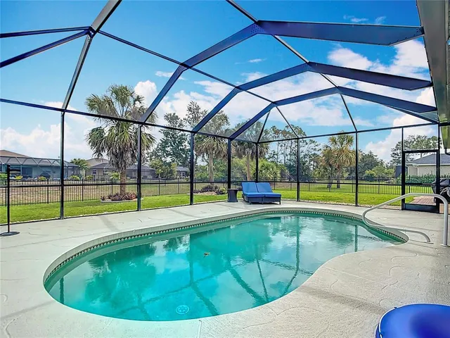 a kitchen with granite countertop white cabinets and stainless steel appliances