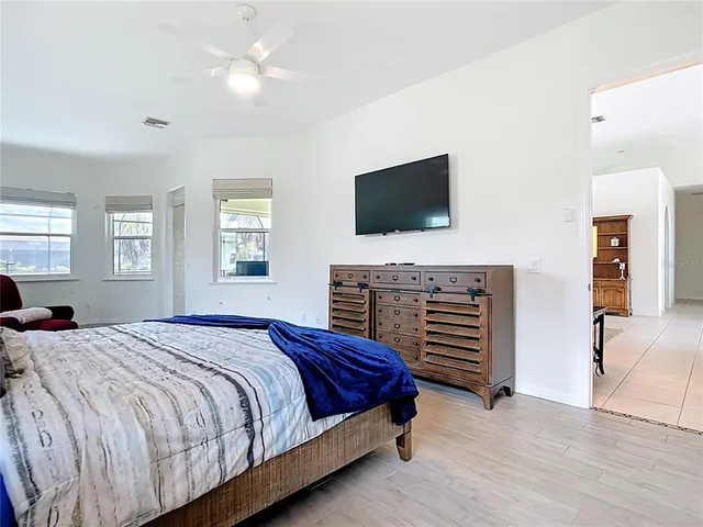 a spacious bathroom with a double vanity sink a mirror a bathtub and a window