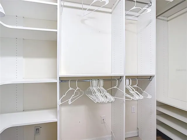 a living room with furniture and floor to ceiling windows