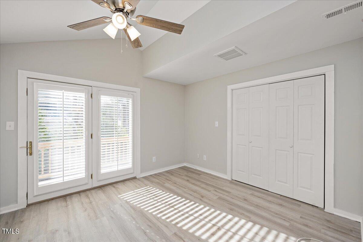 2205 Pastille Lane Raleigh, NC 27612 - Photo 12 of 31 a view of an empty room with wooden floor and a window