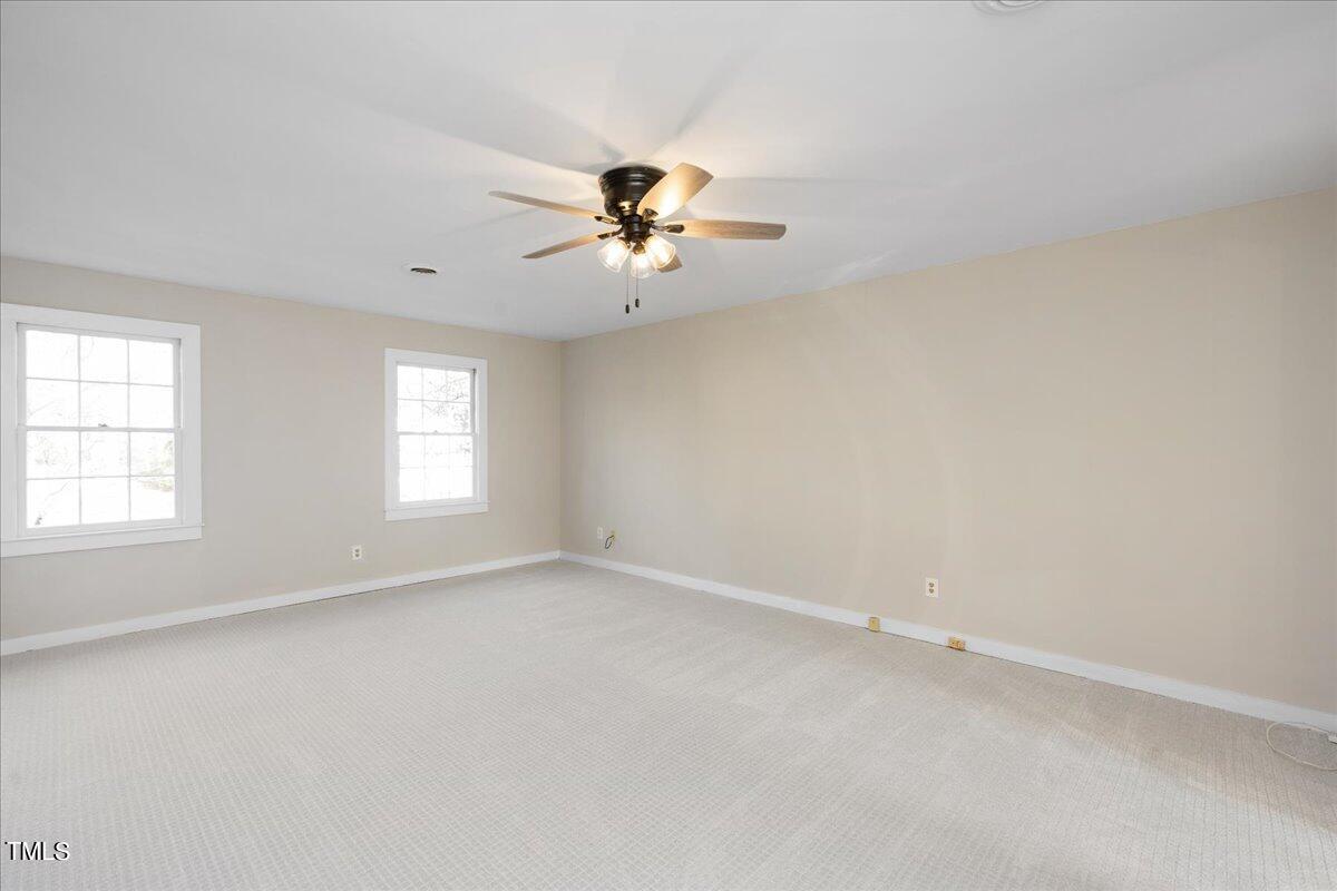 2205 Pastille Lane Raleigh, NC 27612 - Photo 15 of 31 wooden floor in an empty room with a window
