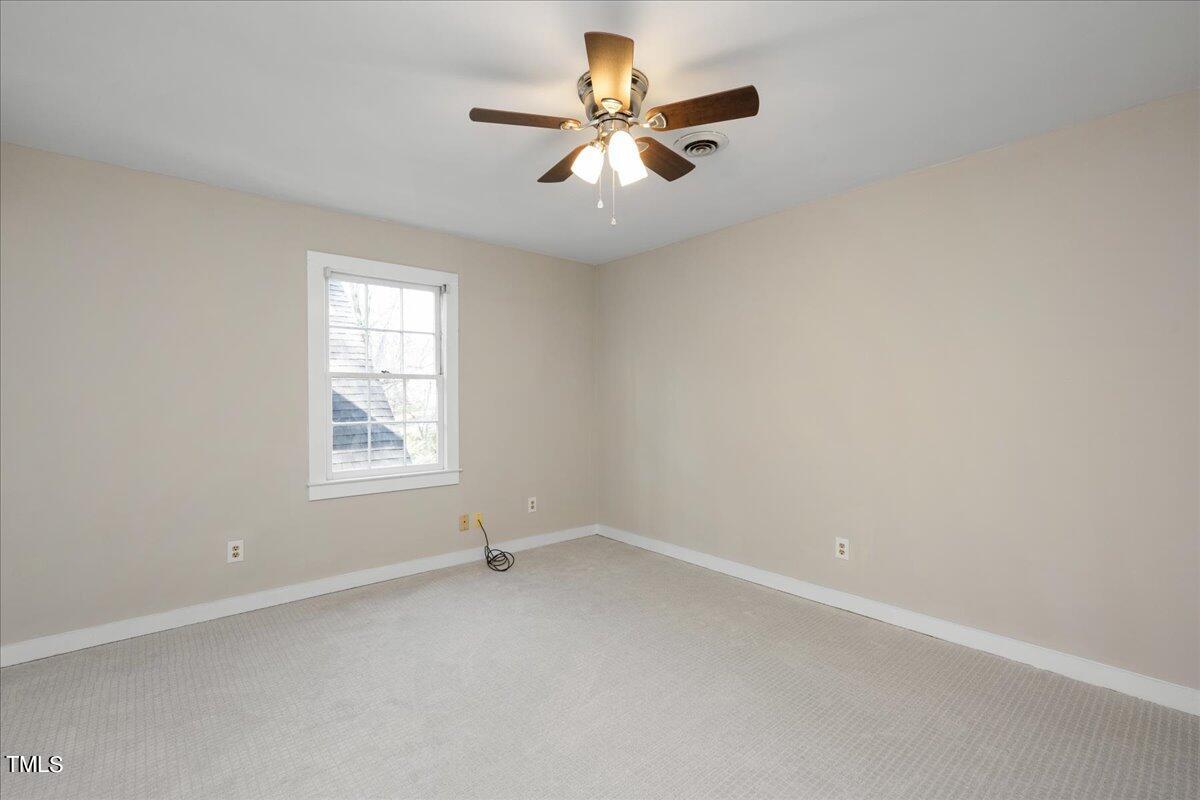 2205 Pastille Lane Raleigh, NC 27612 - Photo 17 of 31 an empty room with a window and a ceiling fan