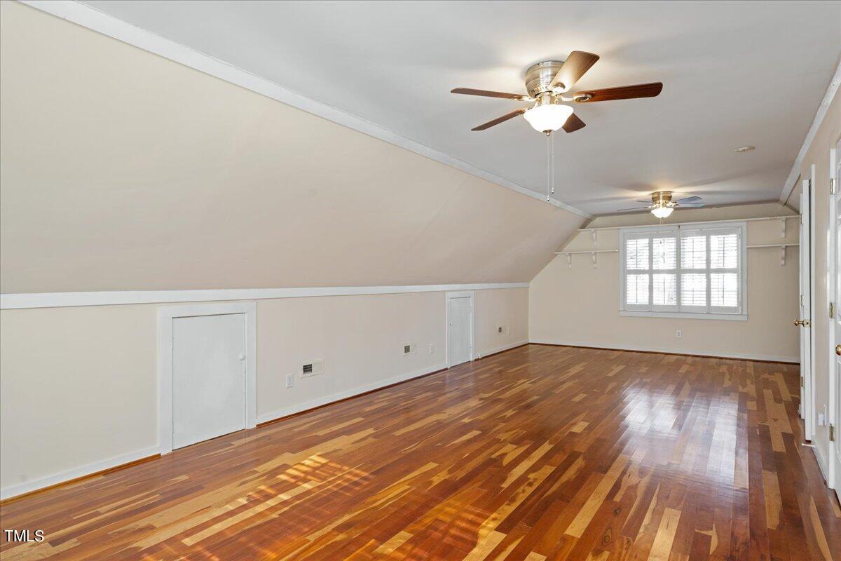 2205 Pastille Lane Raleigh, NC 27612 - Photo 20 of 31 an empty room with wooden floor ceiling fan and windows