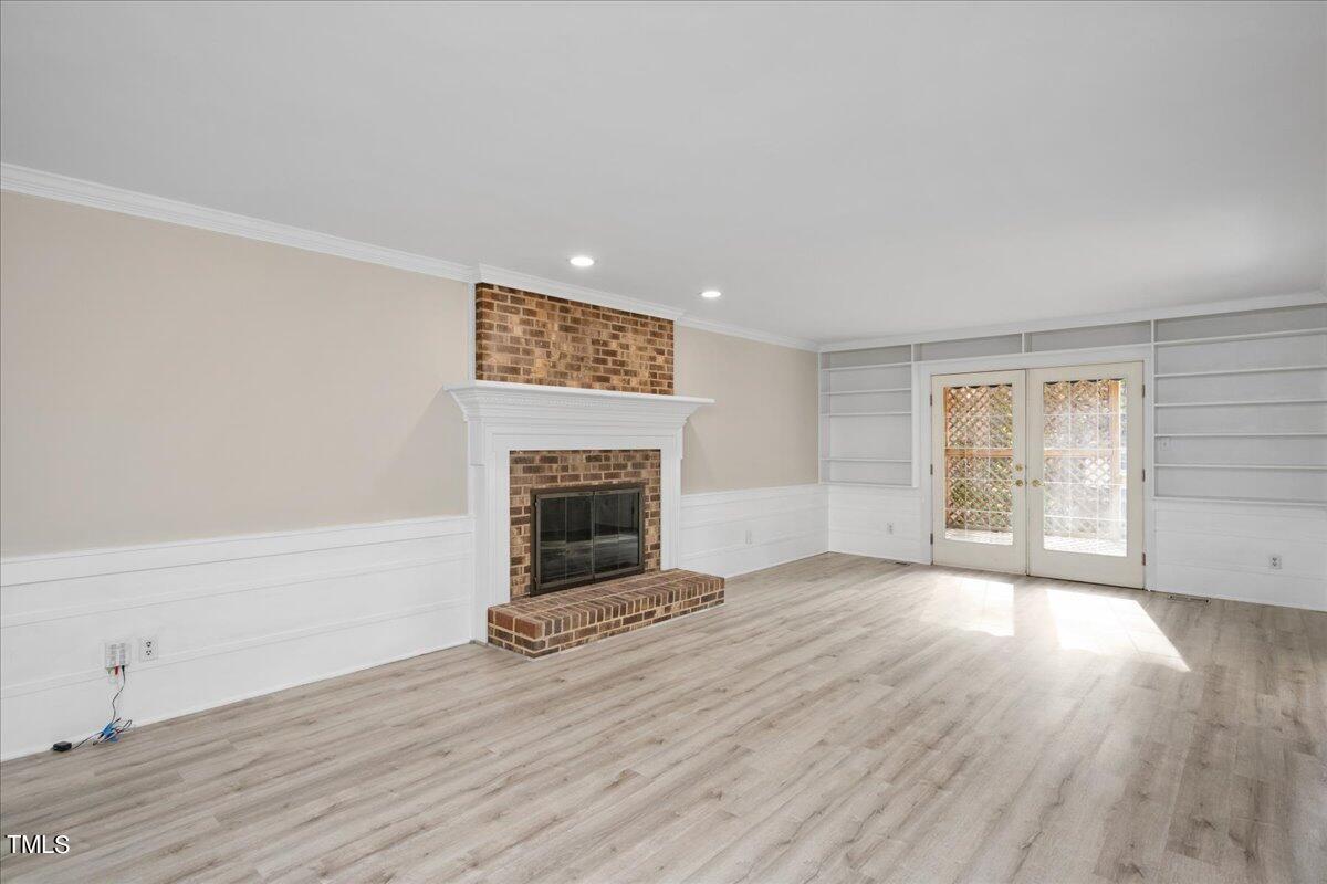 2205 Pastille Lane Raleigh, NC 27612 - Photo 2 of 31 a view of empty room with wooden floor and fireplace
