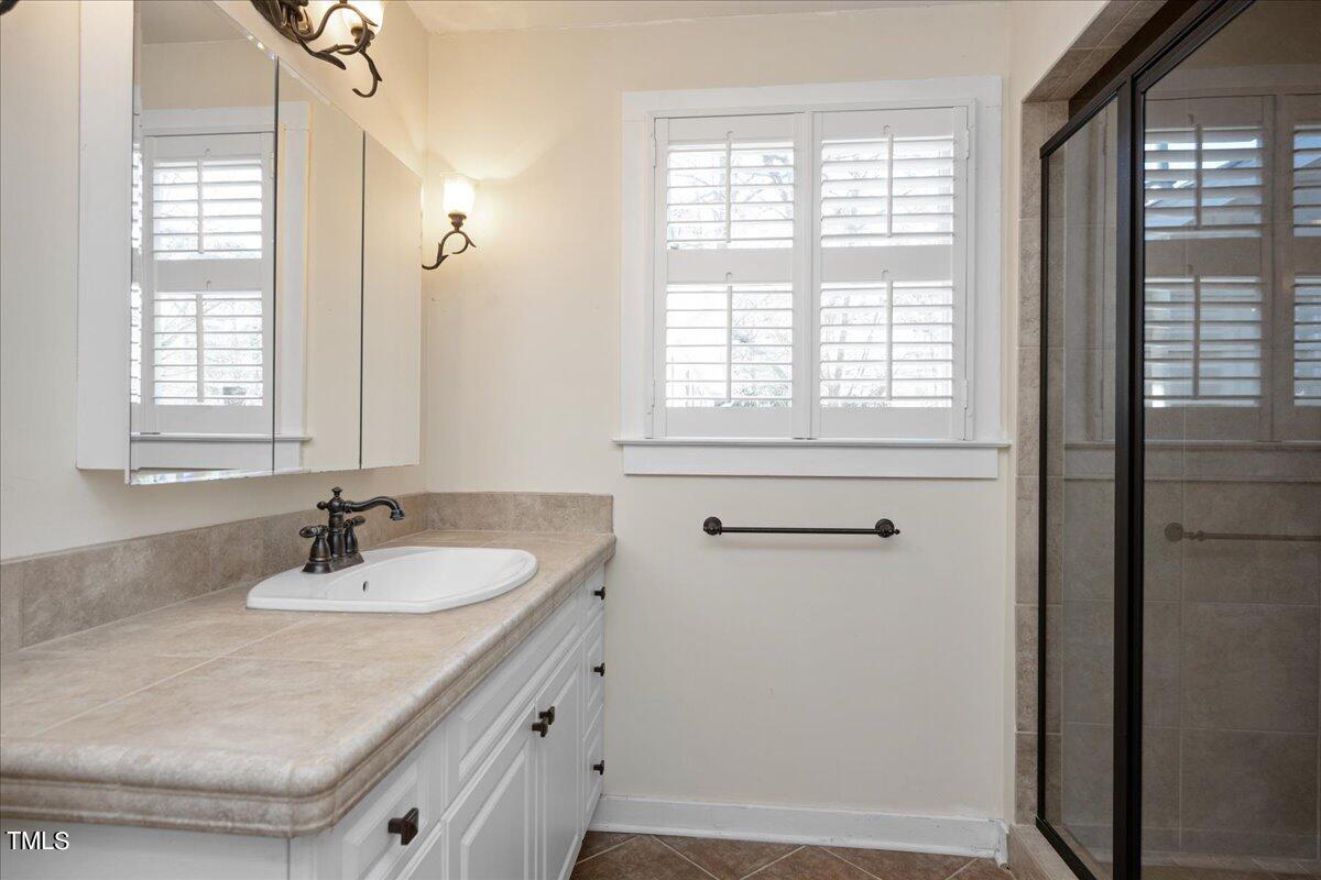 2205 Pastille Lane Raleigh, NC 27612 - Photo 21 of 31 a bathroom with a sink and a window
