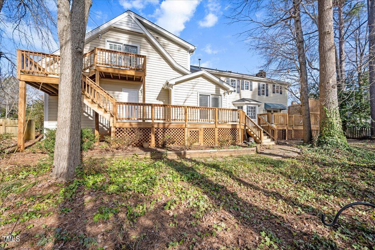 2205 Pastille Lane Raleigh, NC 27612 - Photo 23 of 31 a view of a white house with large windows and a small yard