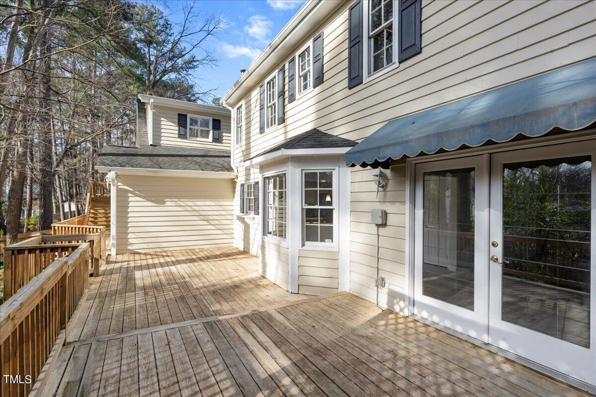 2205 Pastille Lane Raleigh, NC 27612 - Photo 27 of 31 a view of a house with a barbeque and wooden stairs