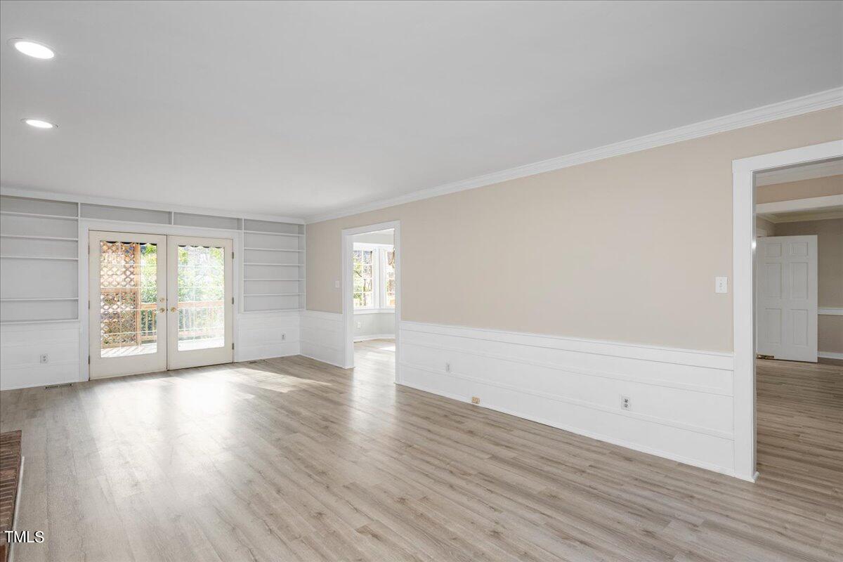 2205 Pastille Lane Raleigh, NC 27612 - Photo 3 of 31 a view of an empty room with wooden floor and a window