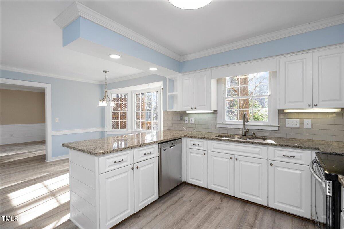 2205 Pastille Lane Raleigh, NC 27612 - Photo 8 of 31 a kitchen with sink stove and cabinets