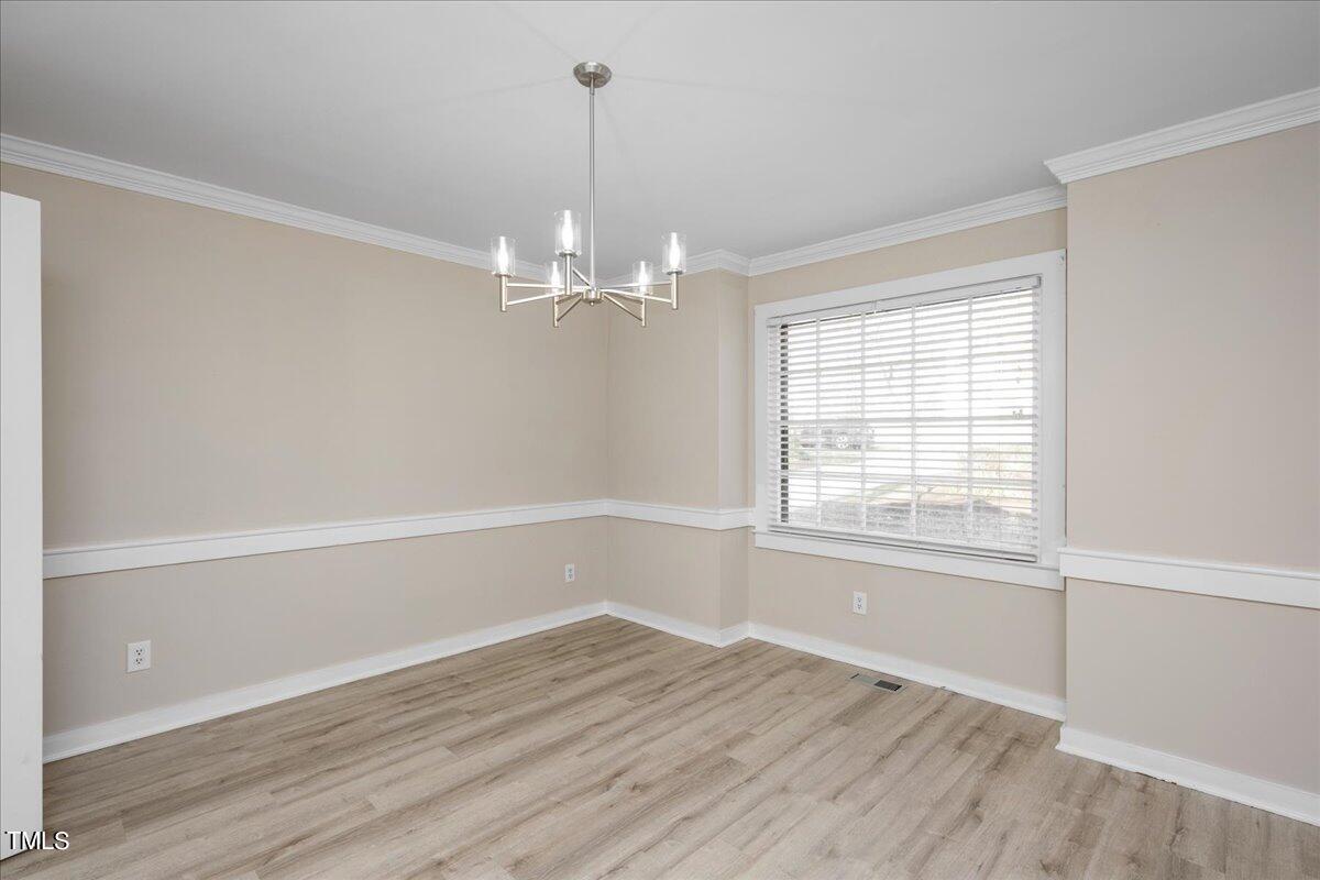 2205 Pastille Lane Raleigh, NC 27612 - Photo 10 of 31 a view of an empty room with wooden floor and a window