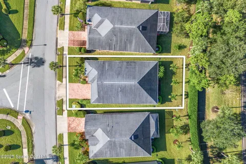an aerial view of residential houses with outdoor space and swimming pool