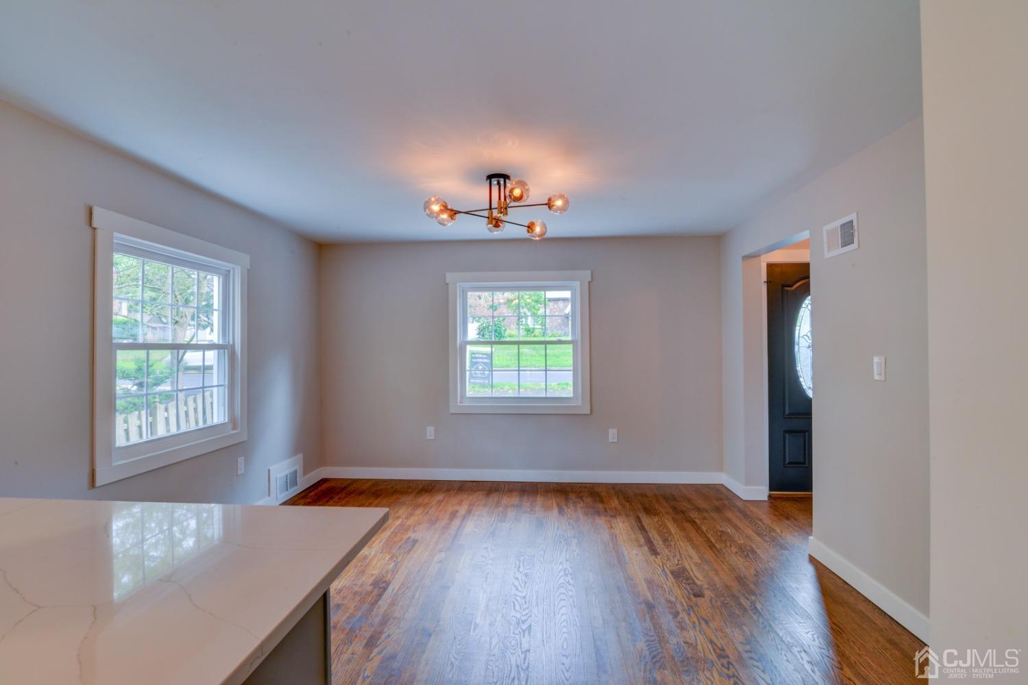 420 Chain O' Hills Road Colonia, NJ 07067 - Photo 11 of 37 an empty room with wooden floor and windows