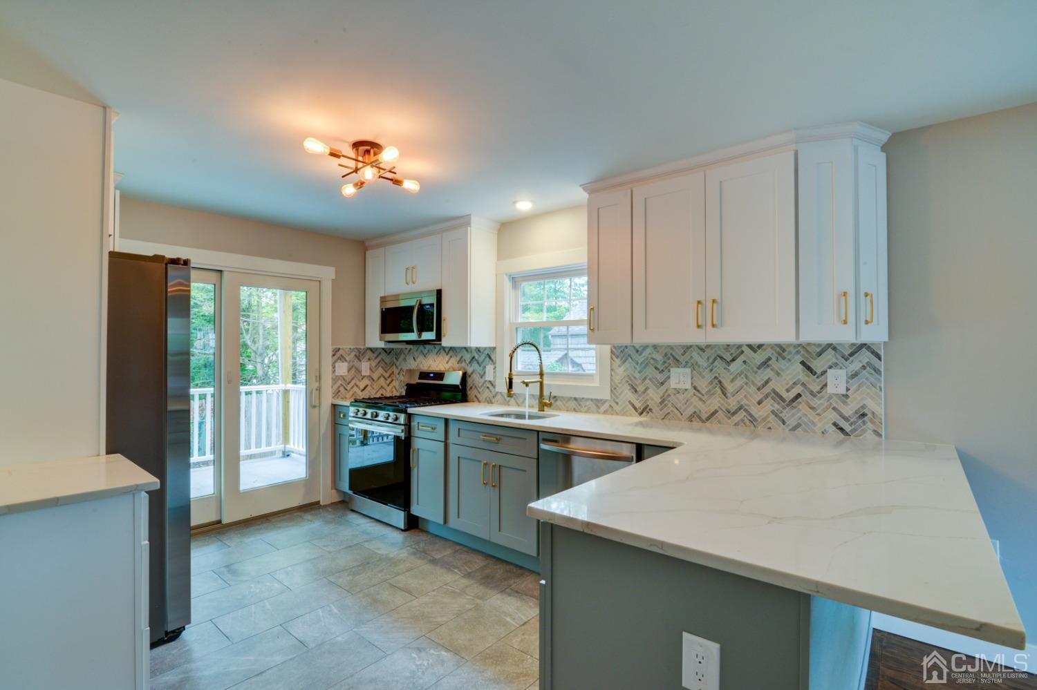 420 Chain O' Hills Road Colonia, NJ 07067 - Photo 13 of 37 a kitchen that has a sink and a stove top oven
