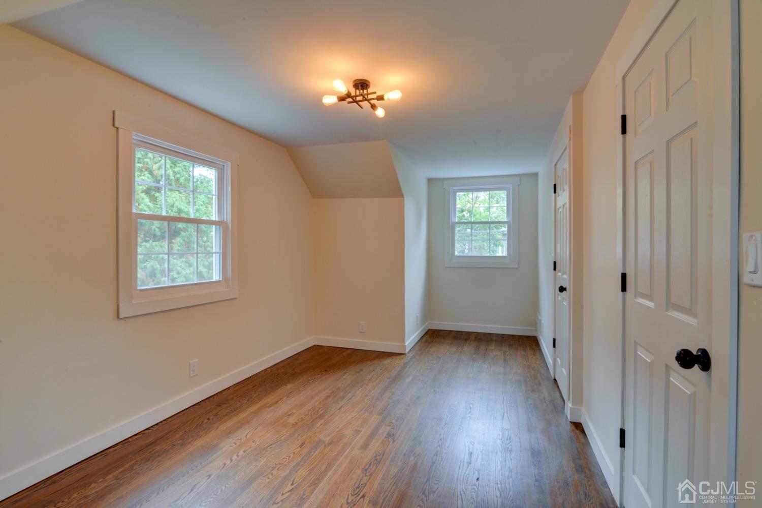 420 Chain O' Hills Road Colonia, NJ 07067 - Photo 18 of 37 a view of an empty room with wooden floor and a window