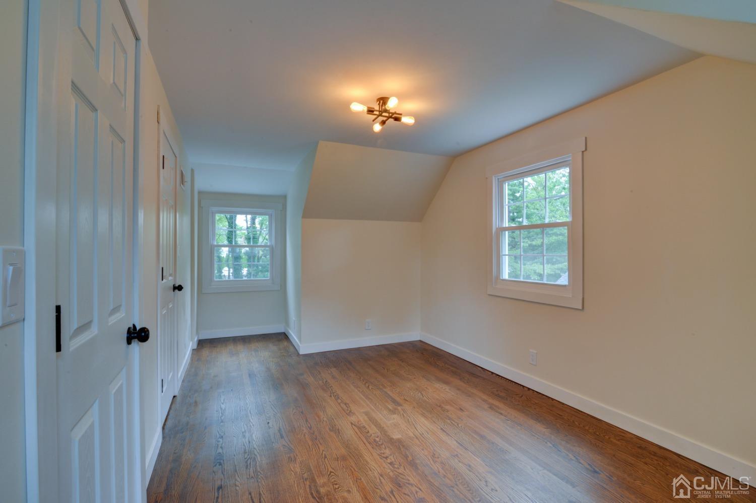 420 Chain O' Hills Road Colonia, NJ 07067 - Photo 19 of 37 wooden floor in an empty room with a window
