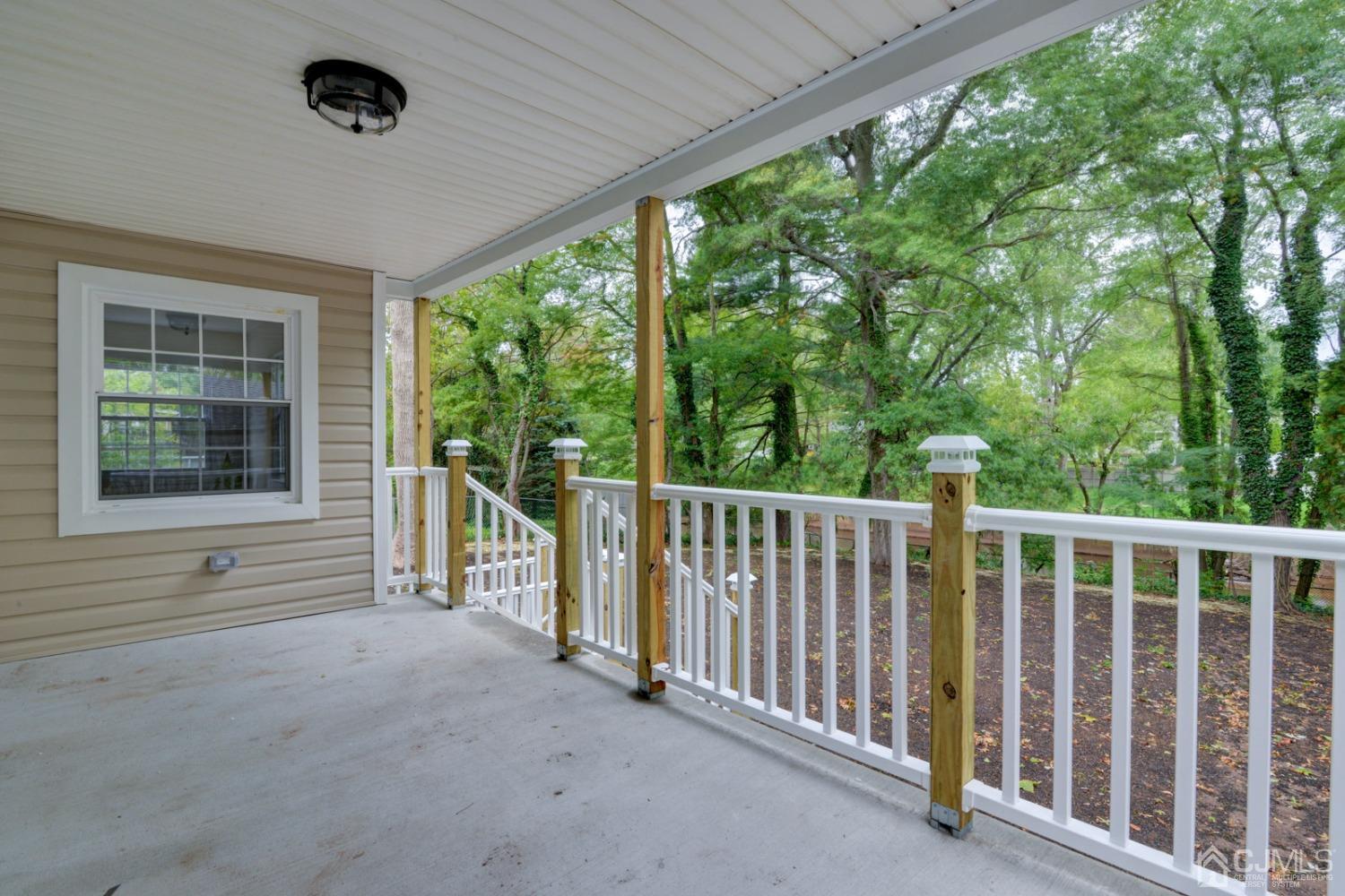 420 Chain O' Hills Road Colonia, NJ 07067 - Photo 36 of 37 a view of a deck with a large window and wooden fence