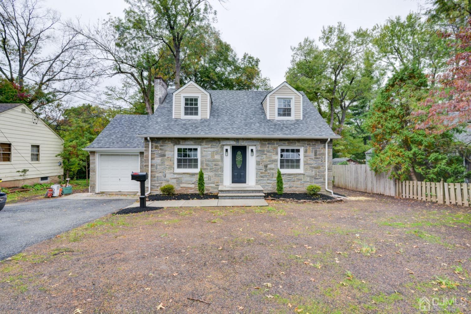 420 Chain O' Hills Road Colonia, NJ 07067 - Photo 37 of 37 a front view of a house with a garden and trees