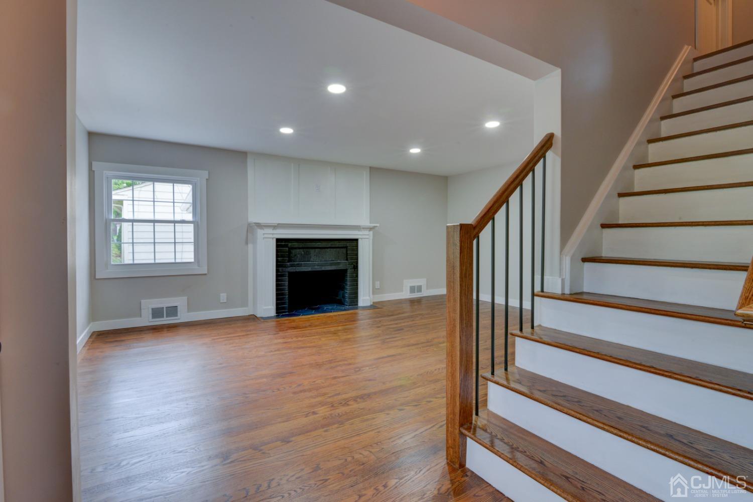 420 Chain O' Hills Road Colonia, NJ 07067 - Photo 4 of 37 a view of an empty room with wooden floor fireplace and a window