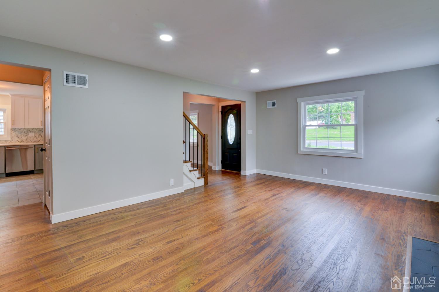 420 Chain O' Hills Road Colonia, NJ 07067 - Photo 6 of 37 an empty room with wooden floor and windows