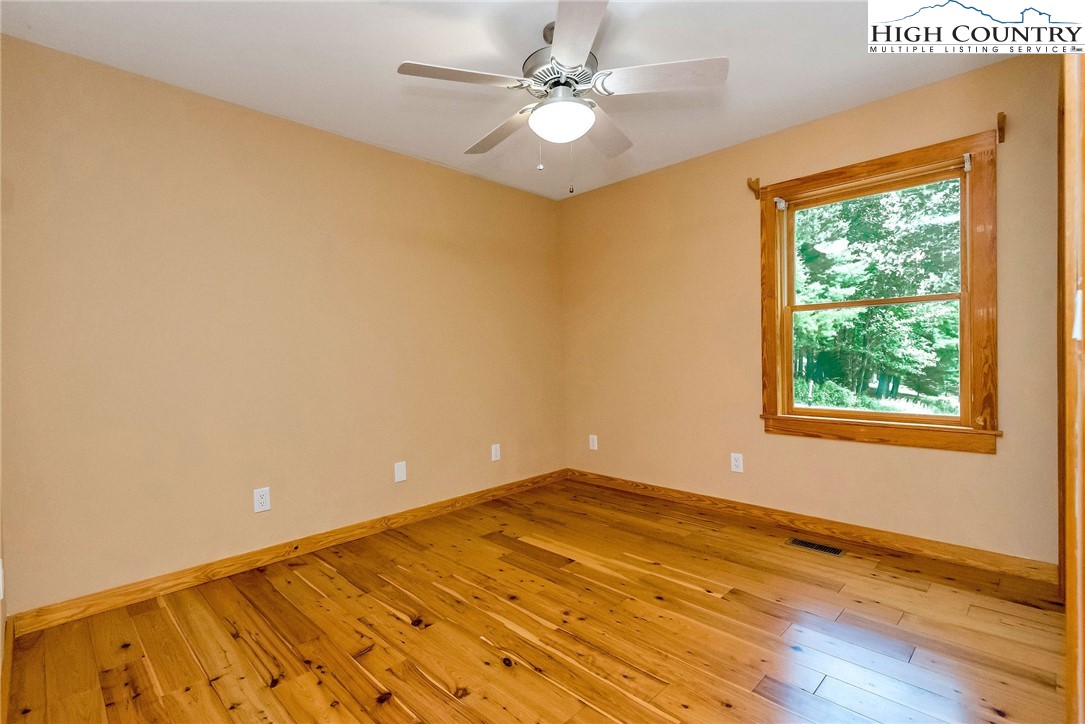 453 South River Hills Road Lansing, NC 28643 - Photo 21 of 48 wooden floor in an empty room with a window