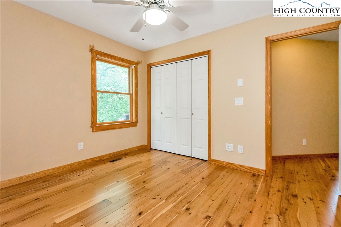 453 South River Hills Road Lansing, NC 28643 - Photo 22 of 48 a view of an empty room with wooden floor and a window
