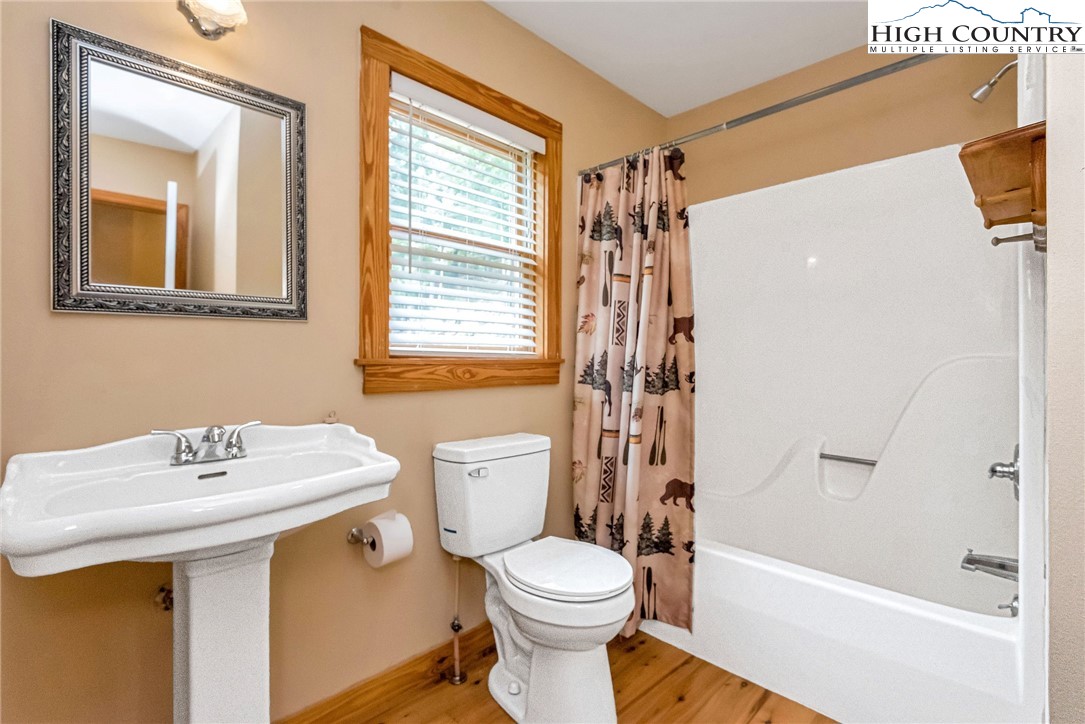 453 South River Hills Road Lansing, NC 28643 - Photo 24 of 48 a bathroom with a sink toilet and shower