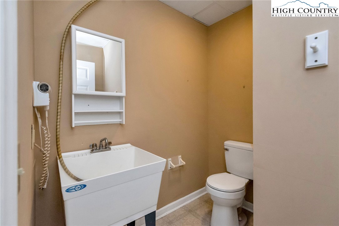 453 South River Hills Road Lansing, NC 28643 - Photo 38 of 48 a bathroom with a sink toilet and mirror