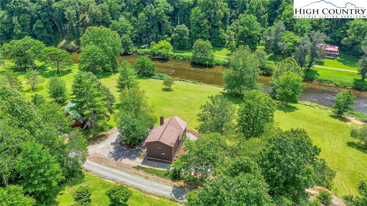 453 South River Hills Road Lansing, NC 28643 - Photo 7 of 48 an aerial view of residential house with outdoor space and trees around