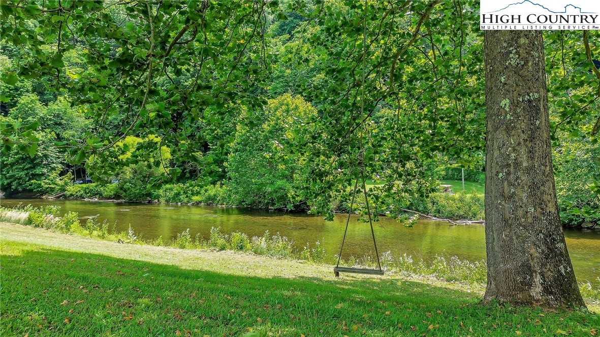 453 South River Hills Road Lansing, NC 28643 - Photo 8 of 48 a view of a lake with a big yard