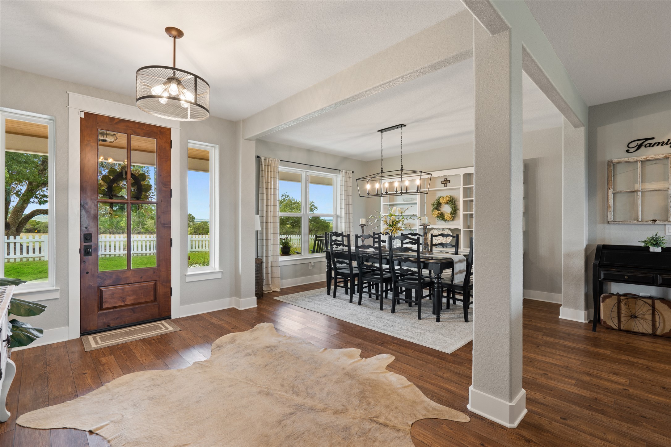 2454 McKinney Loop Blanco, TX 78606 - Photo 13 of 21 a view of a dining room with furniture window and wooden floor