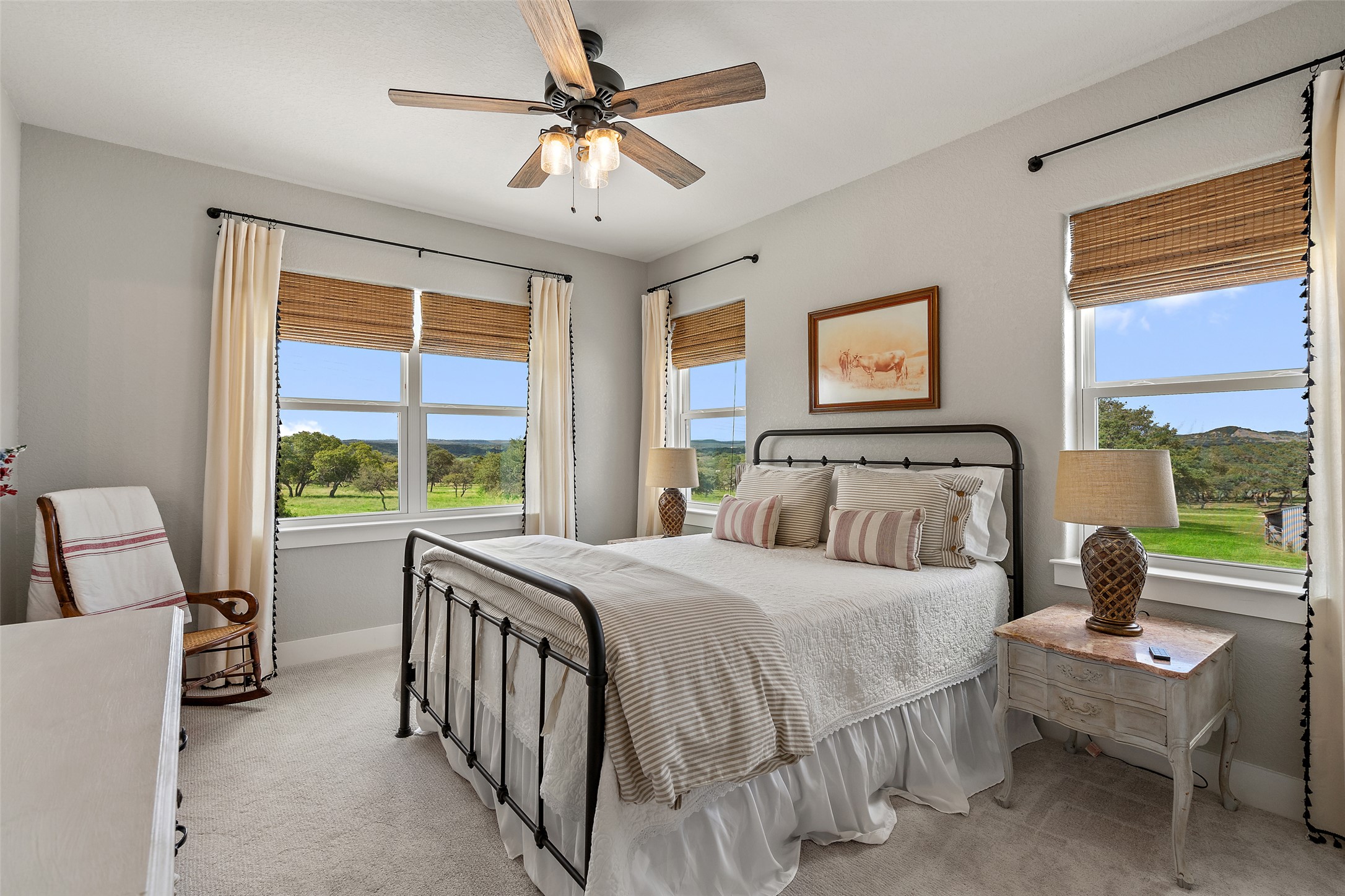 2454 McKinney Loop Blanco, TX 78606 - Photo 16 of 21 a bedroom with a bed and a chandelier