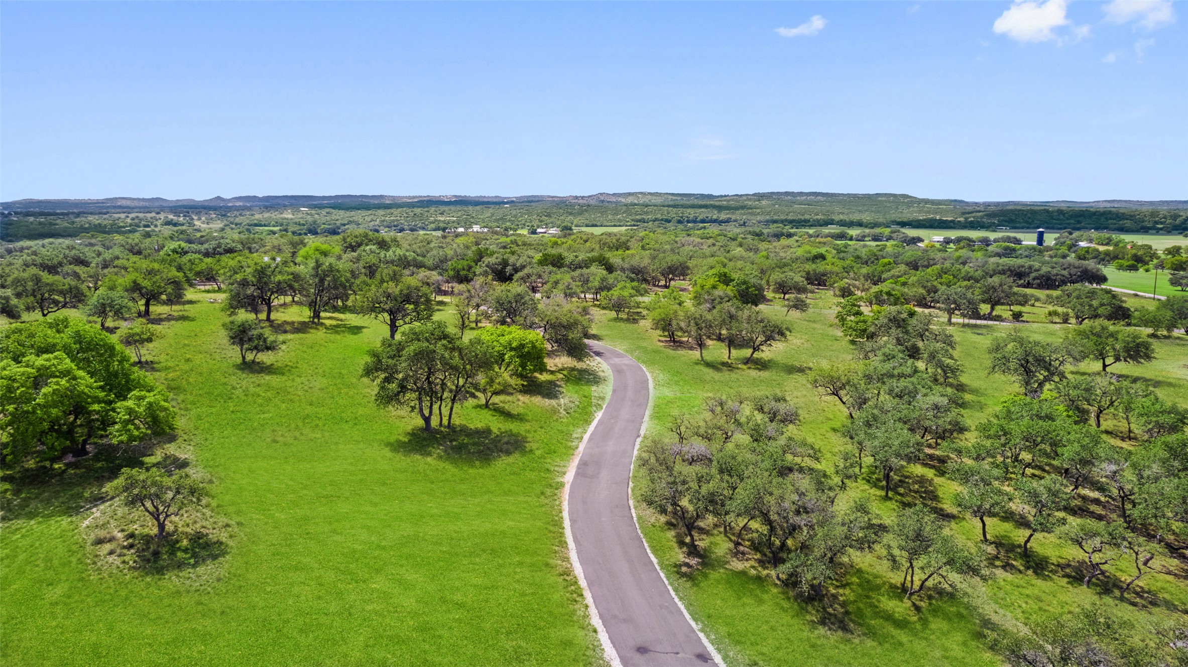 2454 McKinney Loop Blanco, TX 78606 - Photo 19 of 21 a view of a city with lush green forest