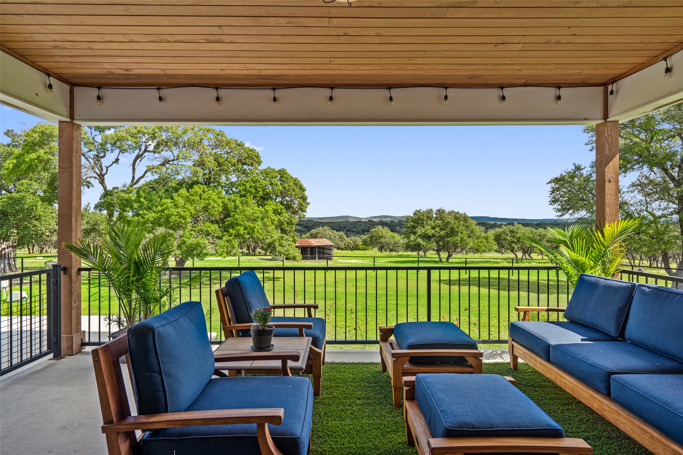 2454 McKinney Loop Blanco, TX 78606 - Photo 2 of 21 a roof deck with a table and chairs