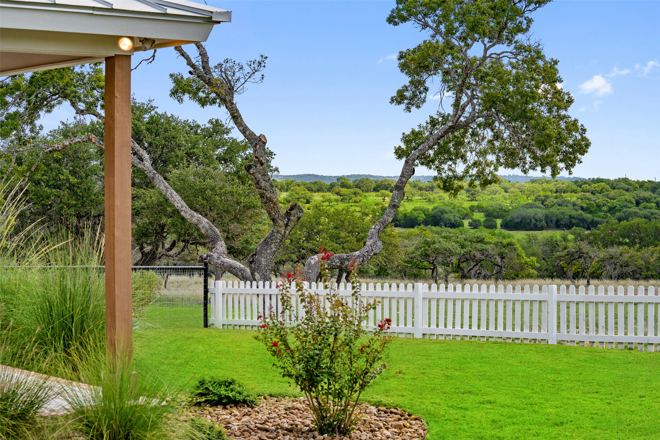 2454 McKinney Loop Blanco, TX 78606 - Photo 7 of 21 a garden view with a flower garden in front of it