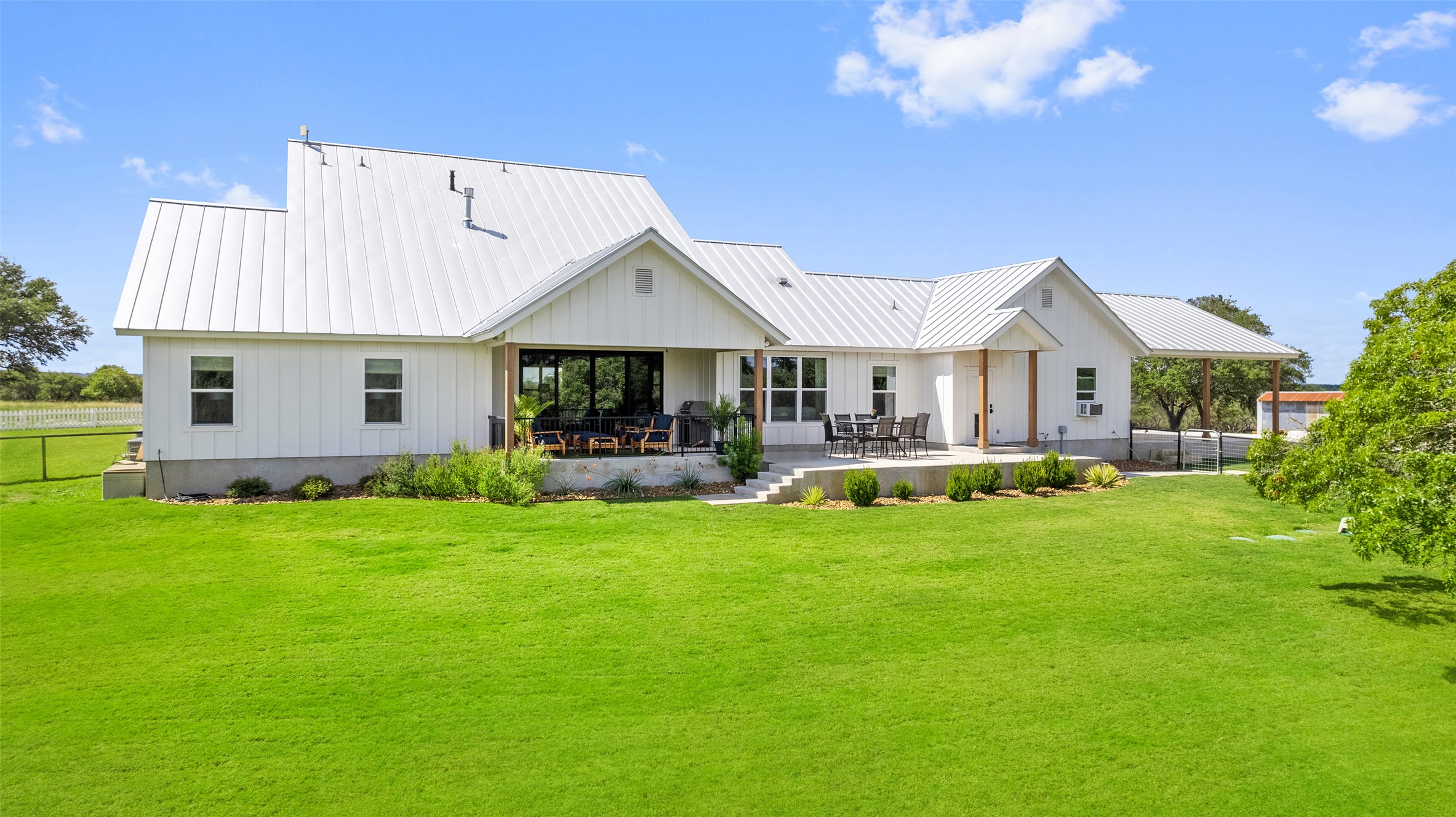 2454 McKinney Loop Blanco, TX 78606 - Photo 10 of 21 a view of a house with a yard porch and sitting area