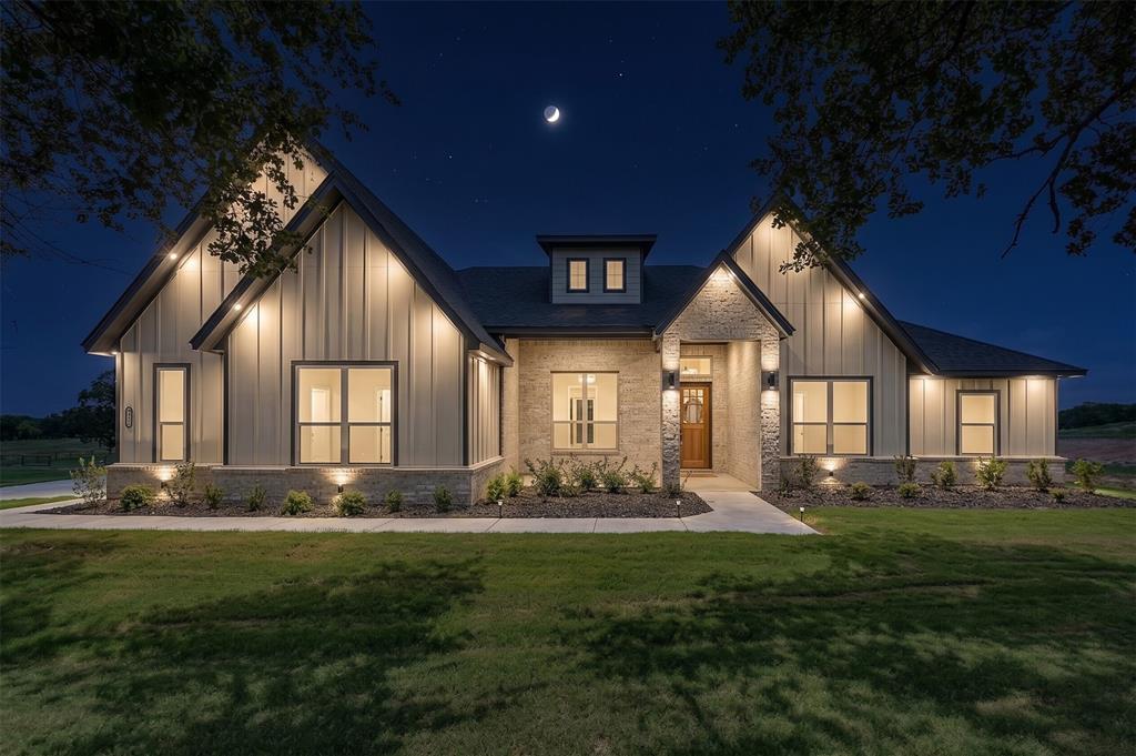 1057 Vh Ranch Poolville, TX 76487 - Photo 2 of 38 a front view of a house with a yard