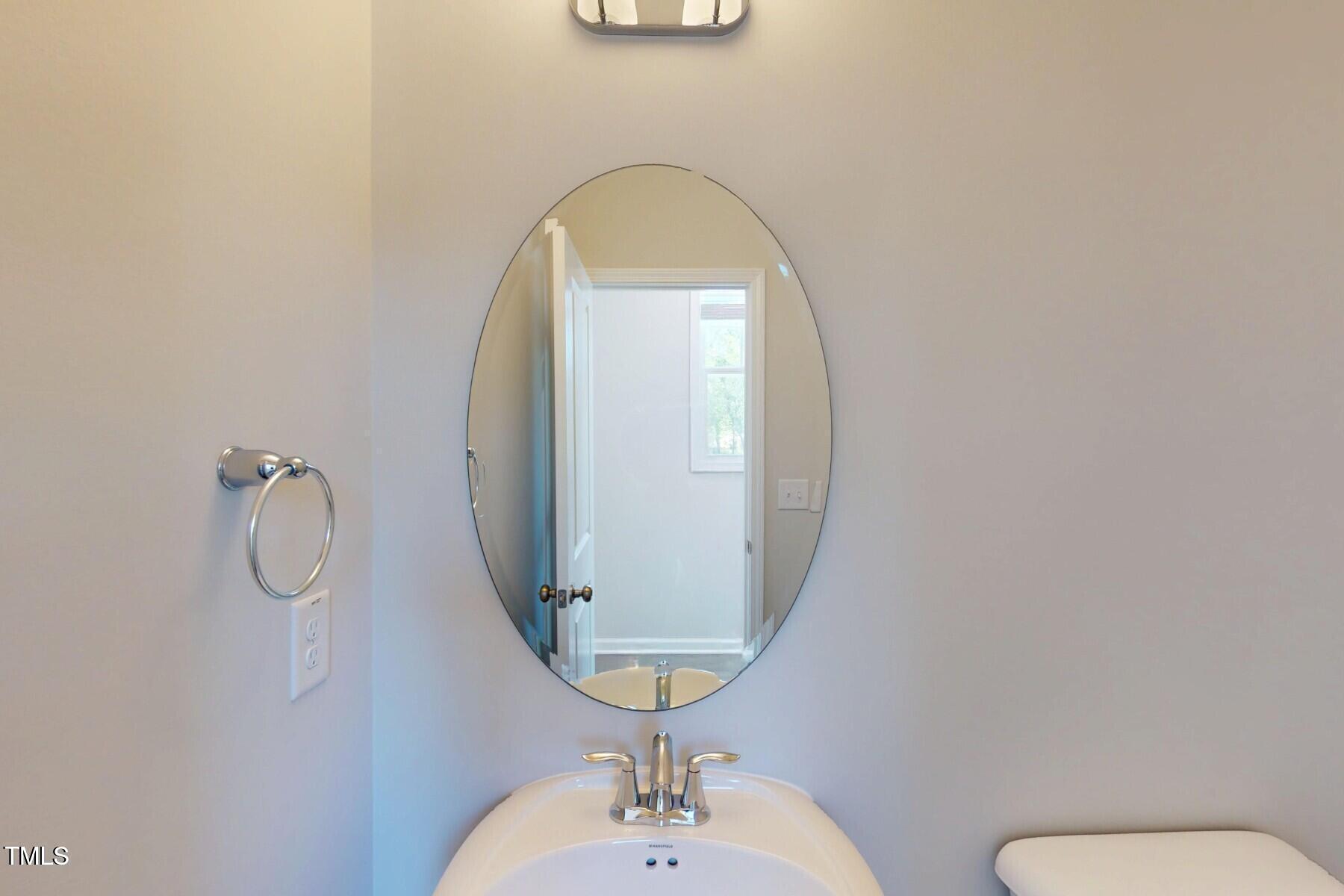 2209 Lambert Road Cary, NC 27519 - Photo 16 of 51 a bathroom with a toilet sink and mirror