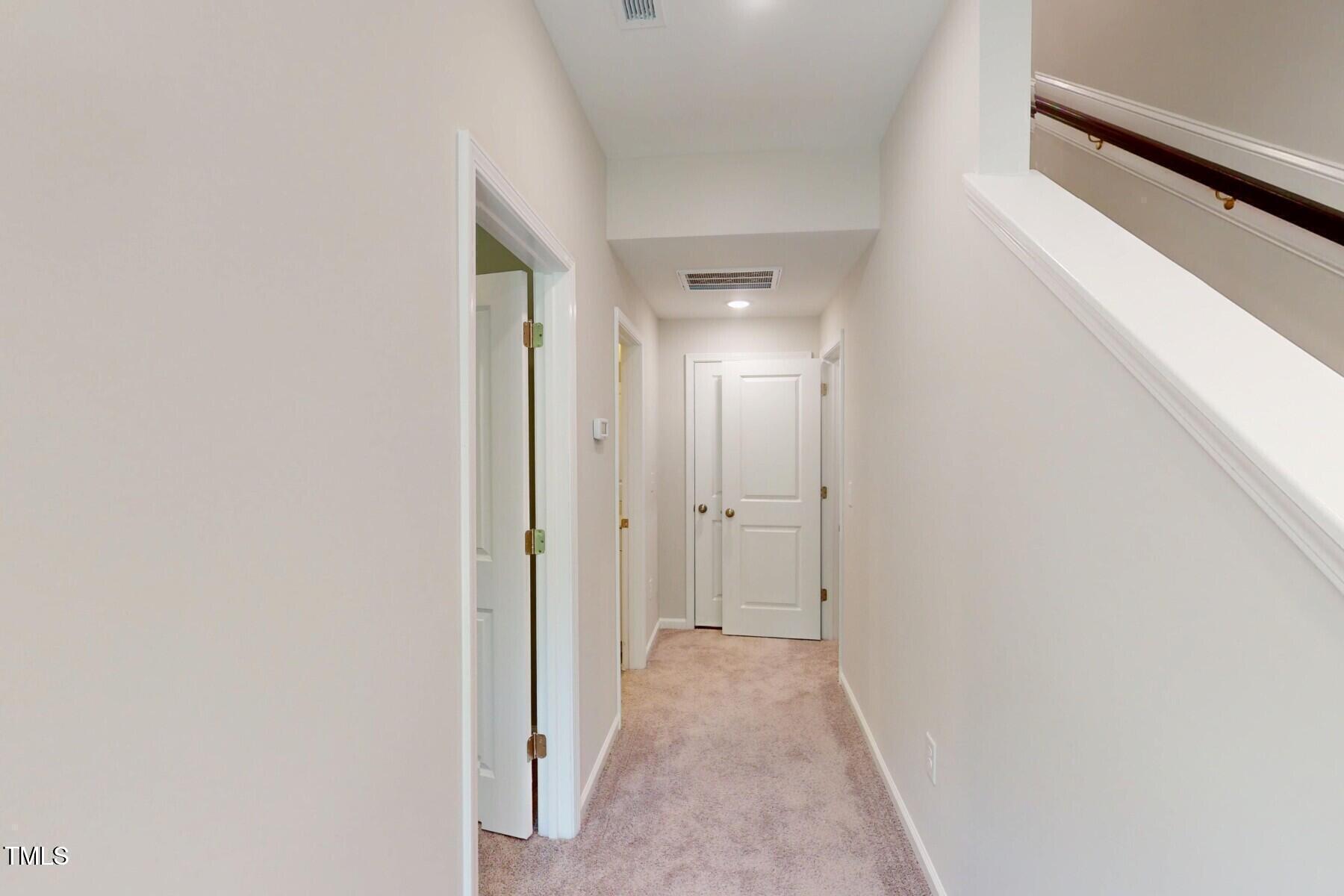 2209 Lambert Road Cary, NC 27519 - Photo 17 of 51 a view of a hallway with wooden floor