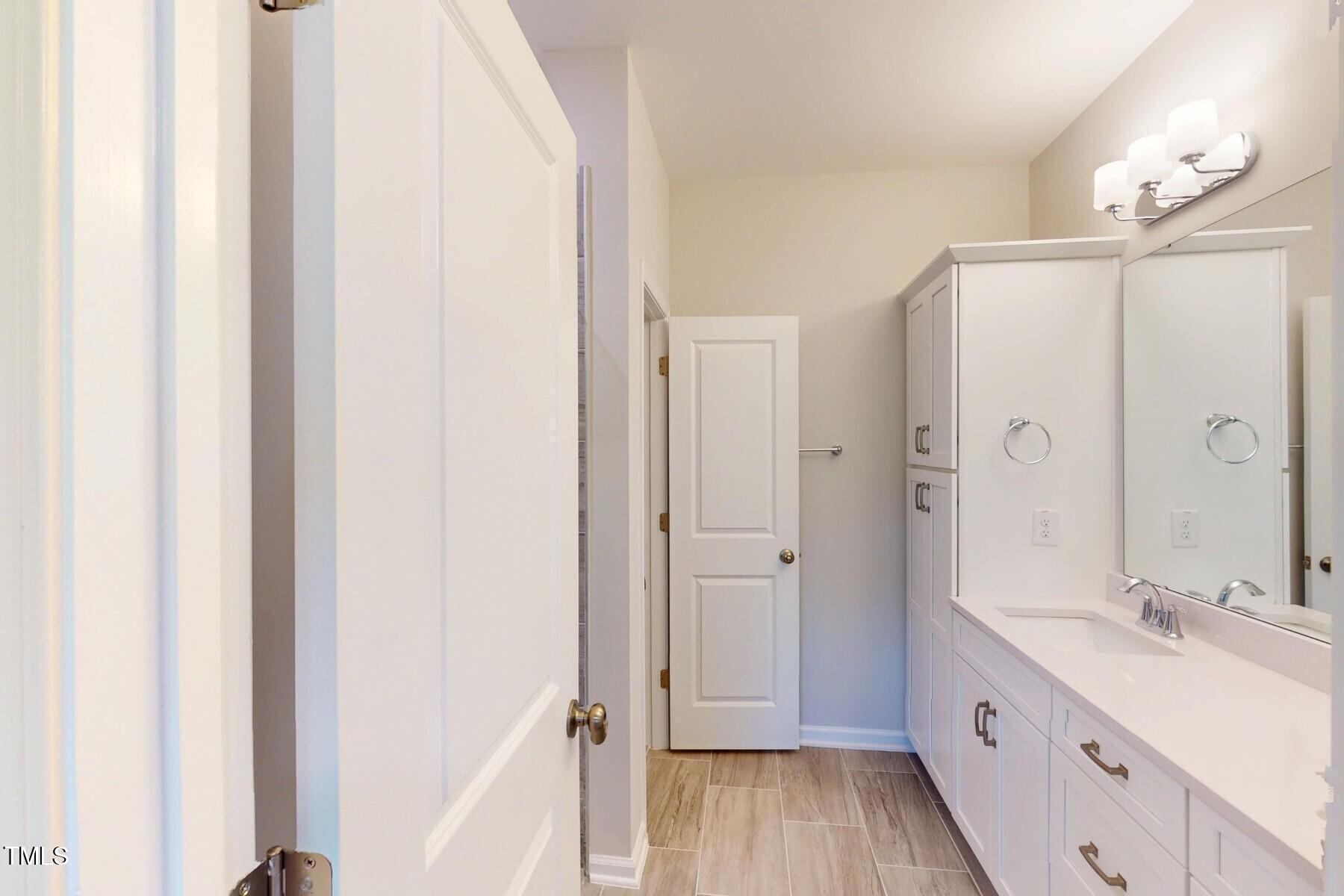 2209 Lambert Road Cary, NC 27519 - Photo 26 of 51 a spacious bathroom with a double vanity sink a mirror and a shower