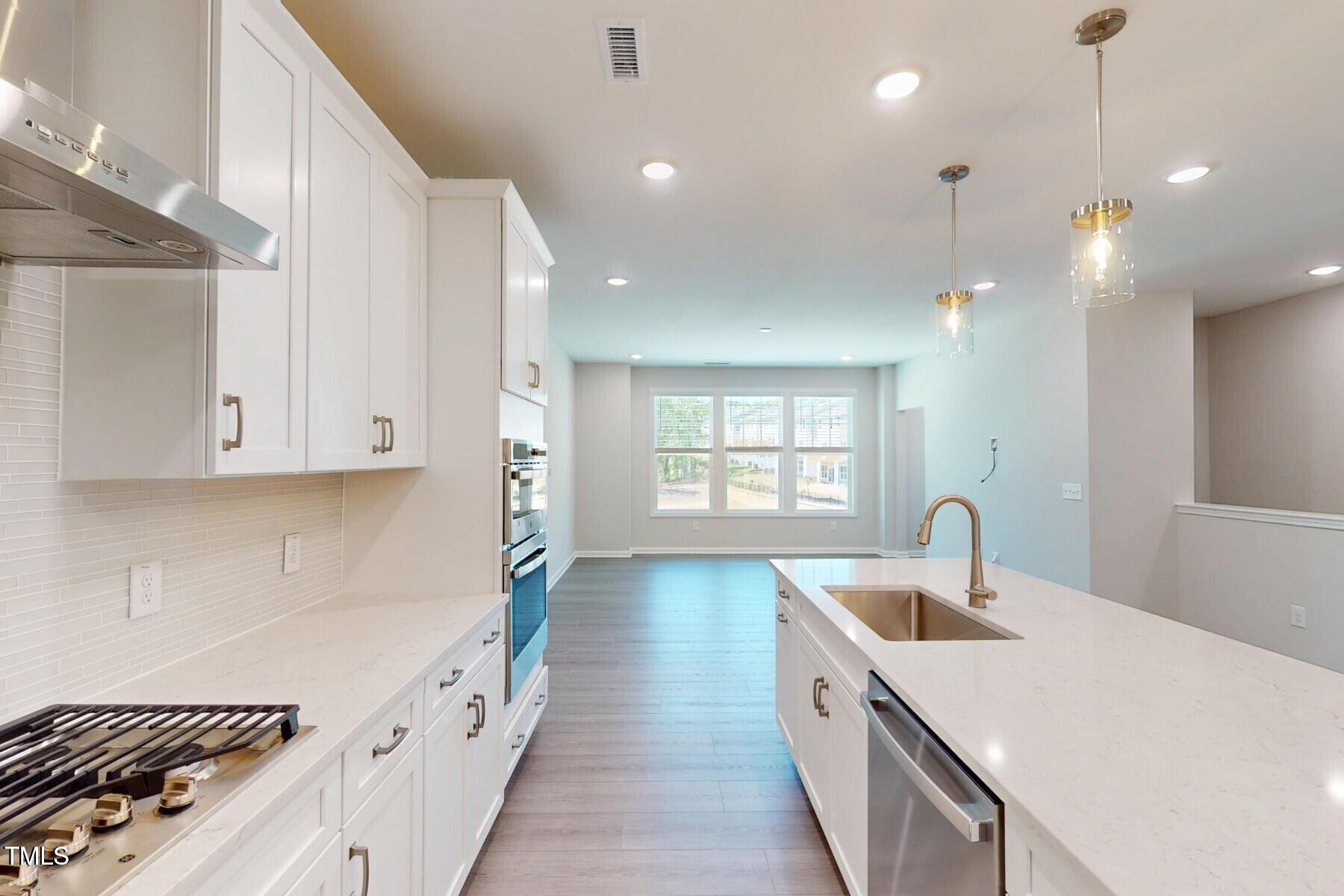 2209 Lambert Road Cary, NC 27519 - Photo 3 of 51 a kitchen with a sink stove and cabinets