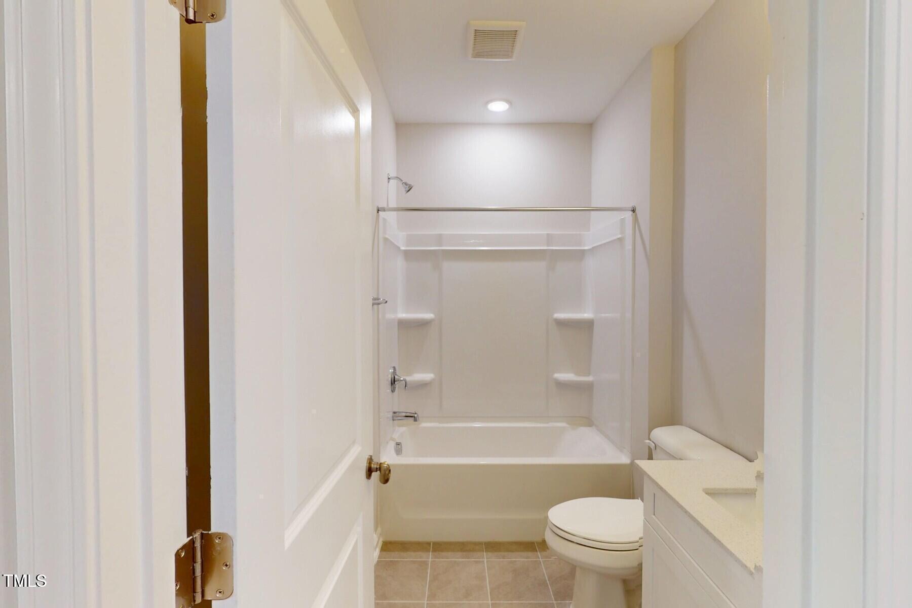 2209 Lambert Road Cary, NC 27519 - Photo 36 of 51 a bathroom with a bathtub shower sink vanity and toilet